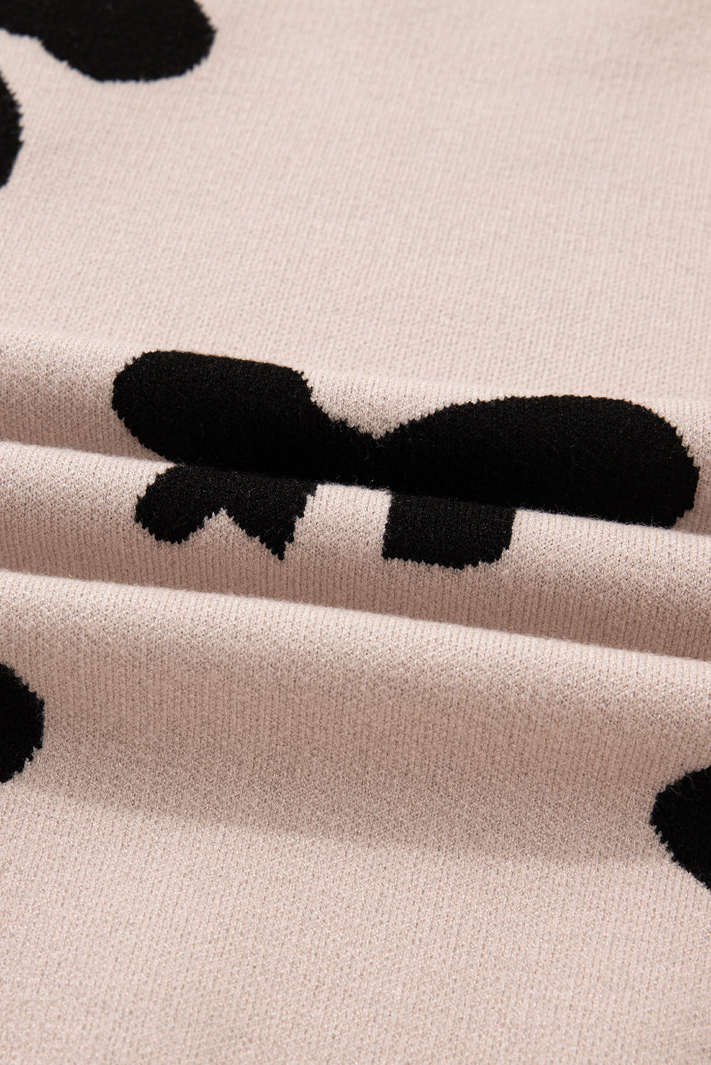 Pull ample à nœud et perles rose vif