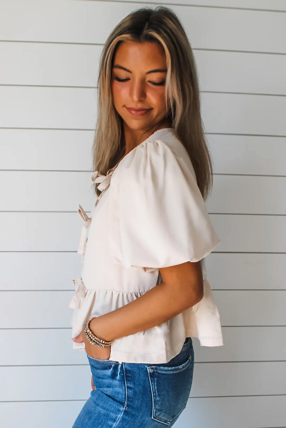 Blusa peplum con mangas abullonadas y lazo blanco dulce