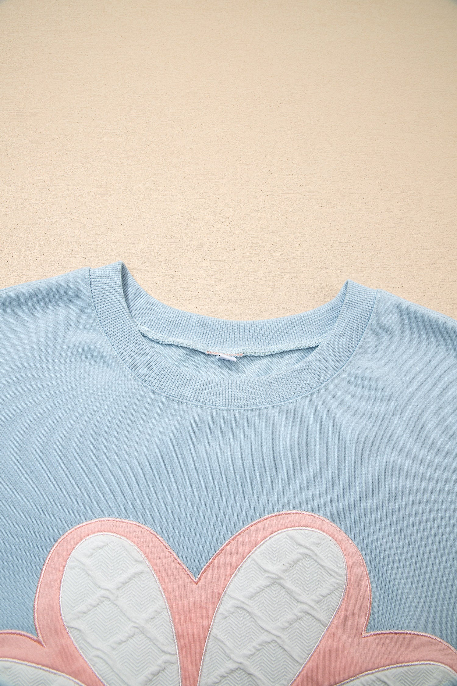 Top de manga larga a rayas con hombros caídos y parche de flores grandes en azul Beau